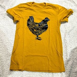 Nice mustard color chicken shirt.  Size youth large.